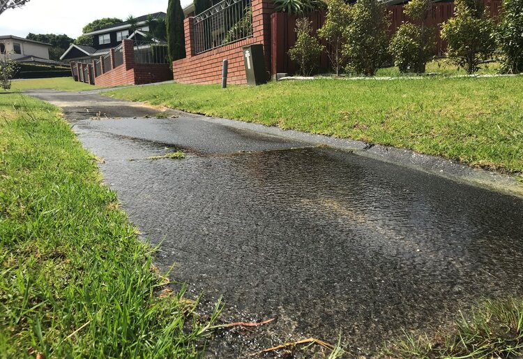 Image of water leaking across a footpath